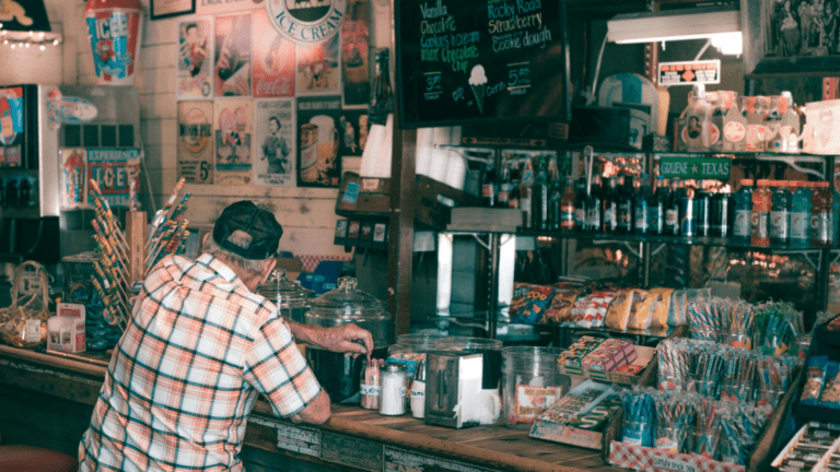Old man getting candy in a shop